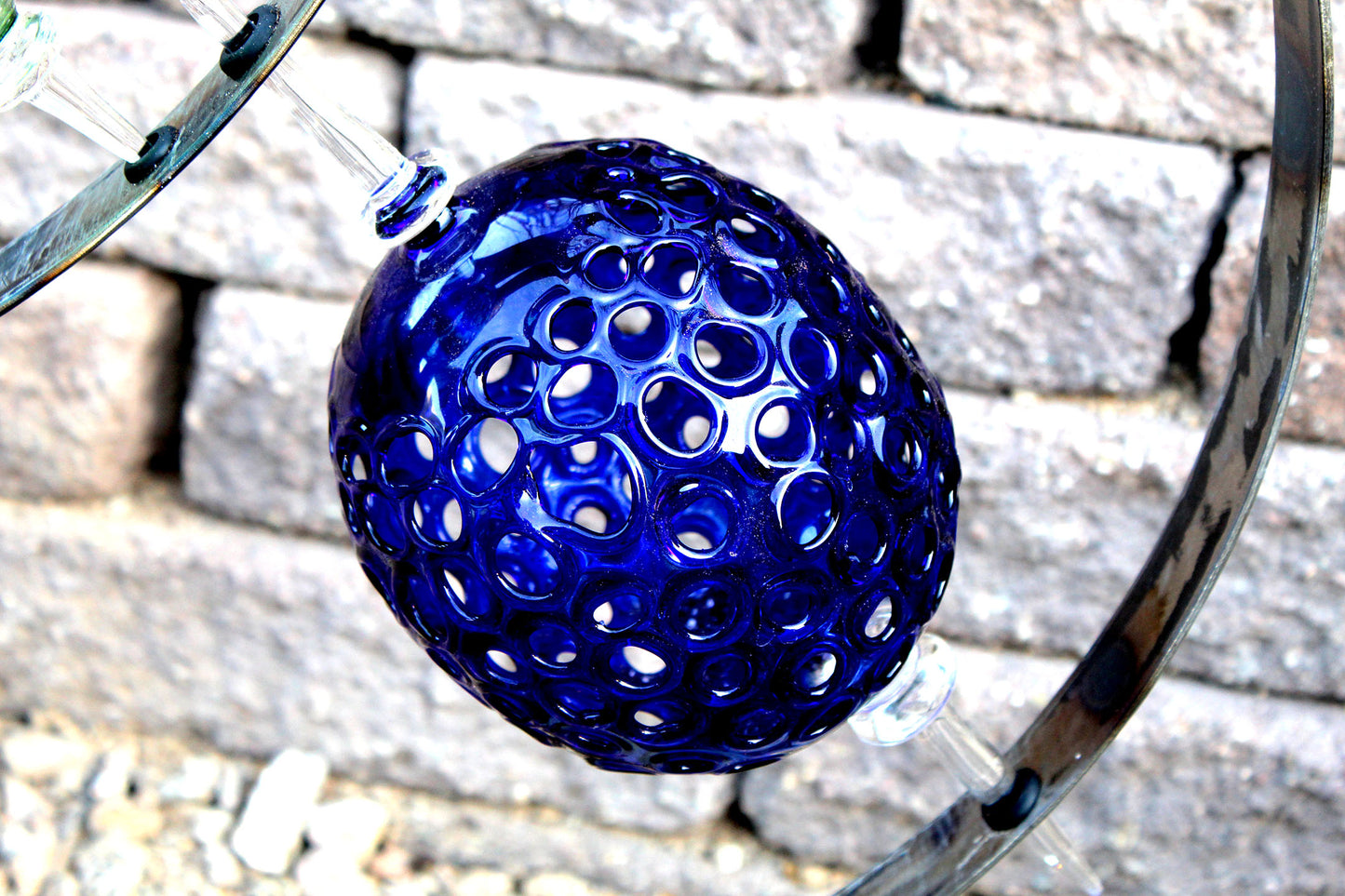 4 Ring metal and borosilicate glass garden sculpture