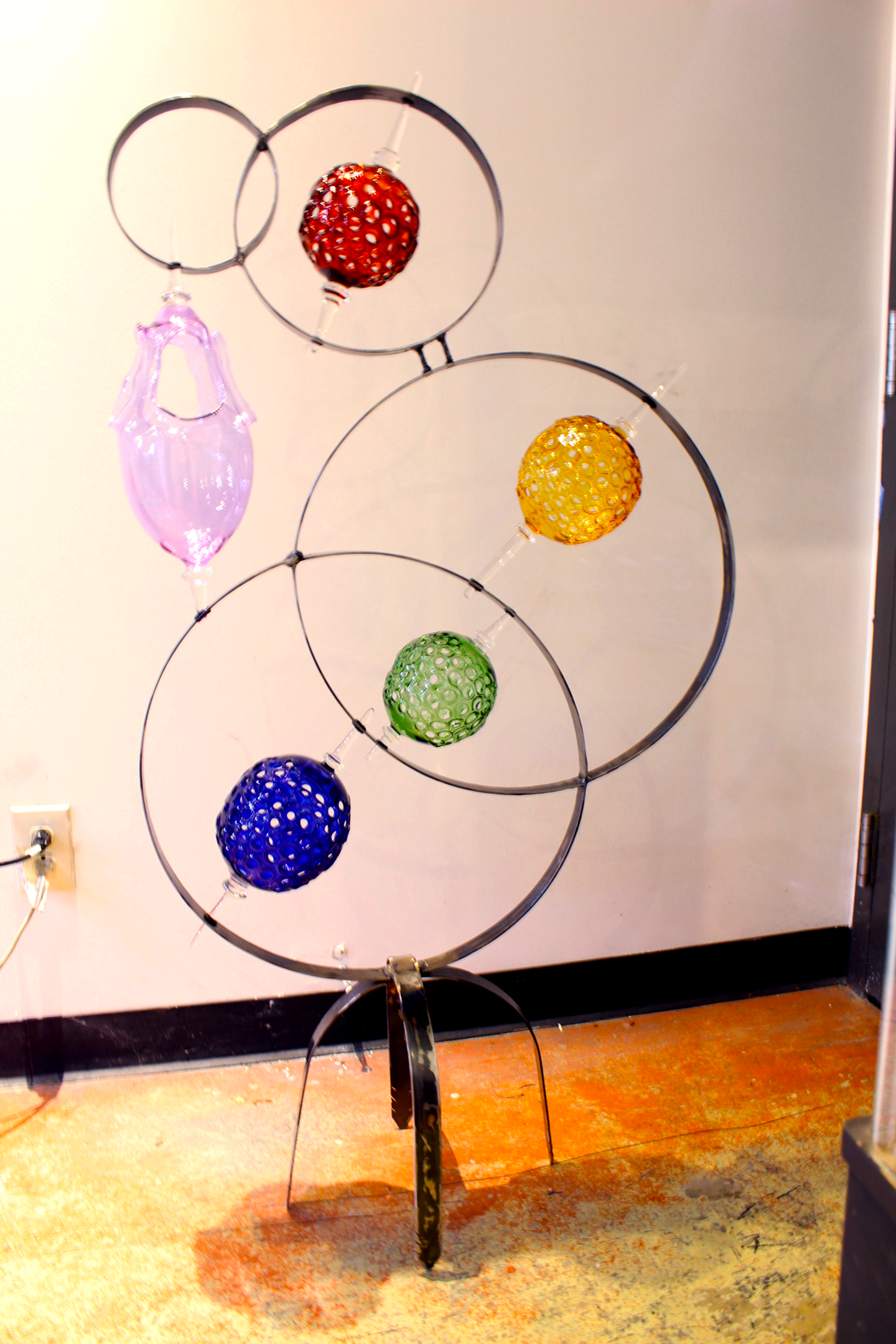 4 Ring metal and borosilicate glass garden sculpture