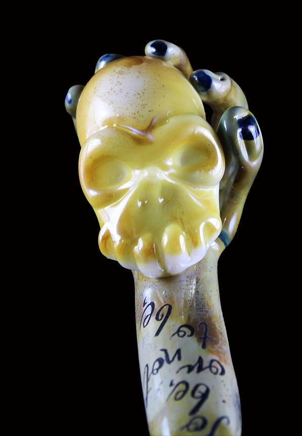 Hand holding white skull pendant by, Phil Sundling and Glass scribe